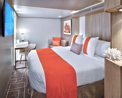 Interior view of a Deluxe Inside Stateroom on the Celebrity Beyond, offering a quiet and comfortable retreat for couples.