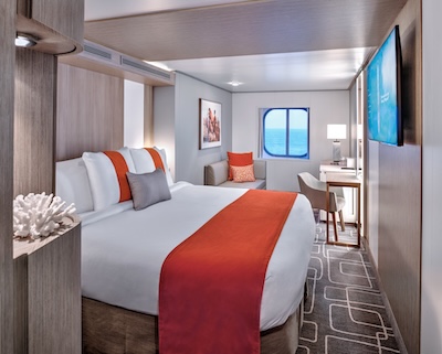 Looking out the large window of an Ocean View Stateroom on the Celebrity Beyond during a relaxing day at sea.