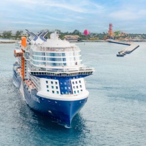 The luxury cruise ship Celebrity Beyond departing a tropical port, the venue for the Christian Marriage Cruise.