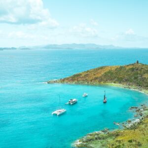 Catamarans anchored in a tranquil turquoise bay in St. Thomas, a relaxing shore excursion option for the Christian Marriage Cruise