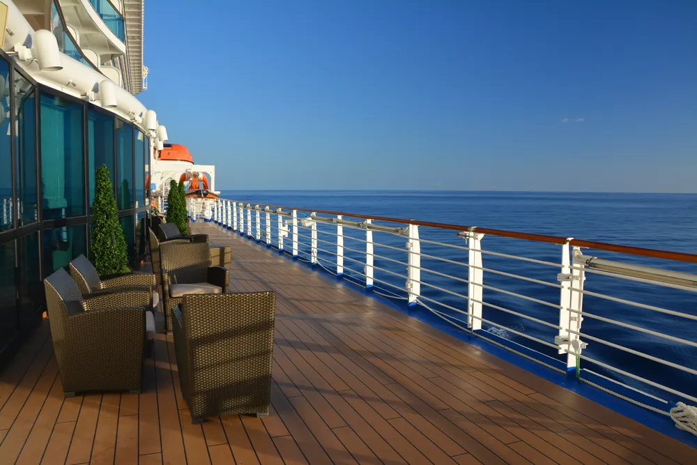 Quiet cruise ship deck looking out over open water in soft morning light