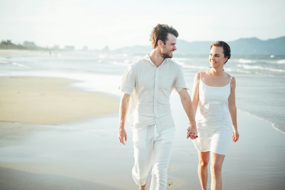 couples spiritual retreat, couple walking together on beach at sunrise