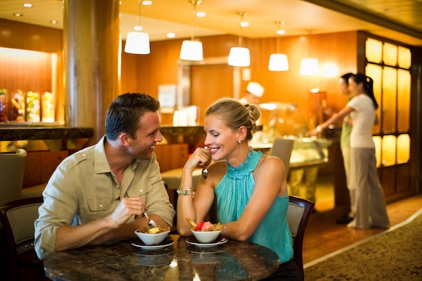 A happy couple enjoys dessert during their Christian marriage cruise vacation on the Celebrity Summit.