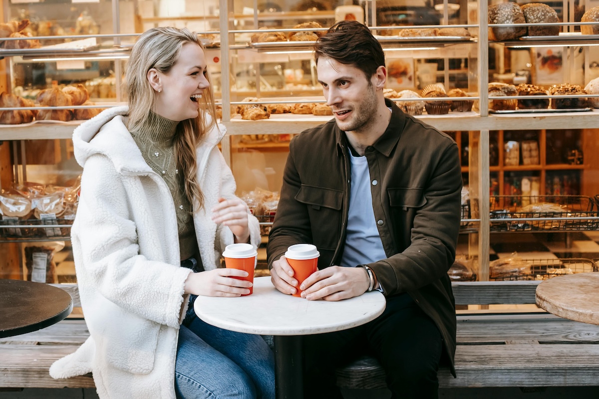 couple discussing marriage retreat options over morning coffee