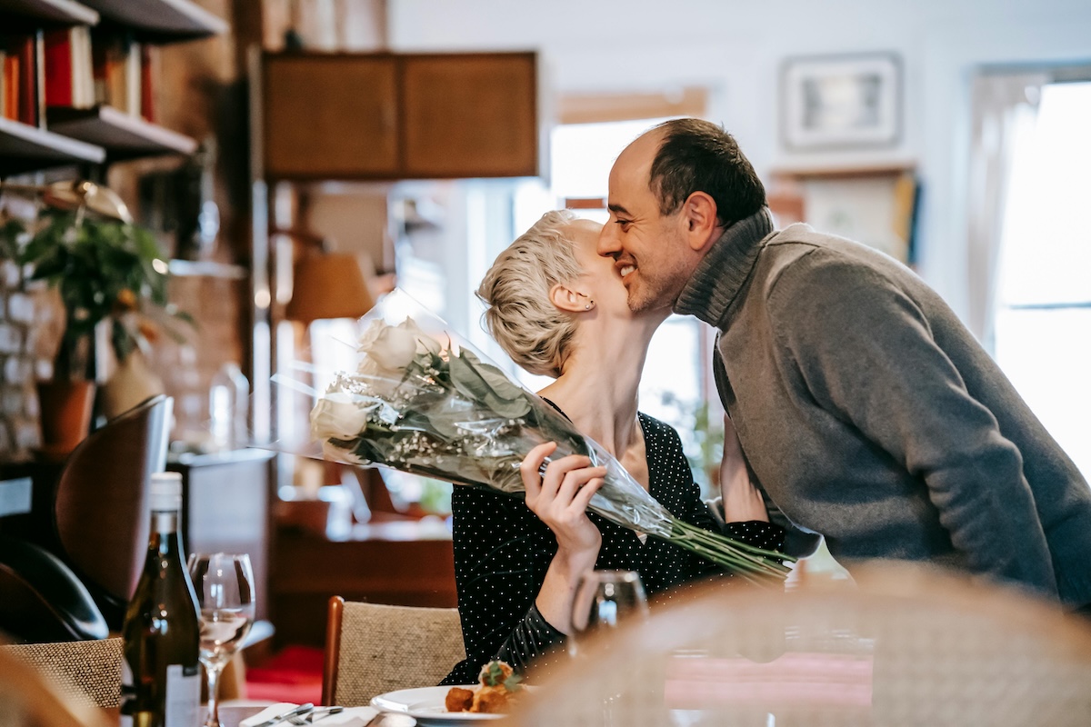 Couple practicing love maps exercise, talking together over dinner